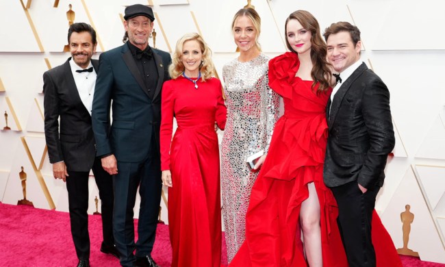 The cast of Coda stand on the Oscars red carpet.