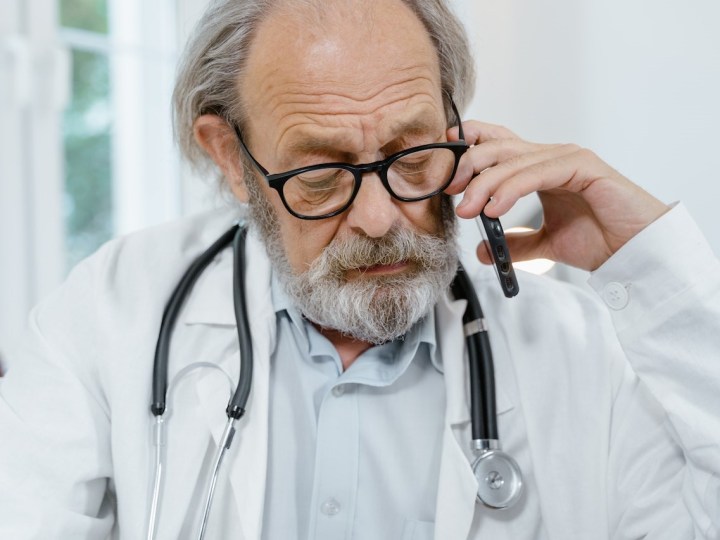 Doctor talking on the phone with patient.