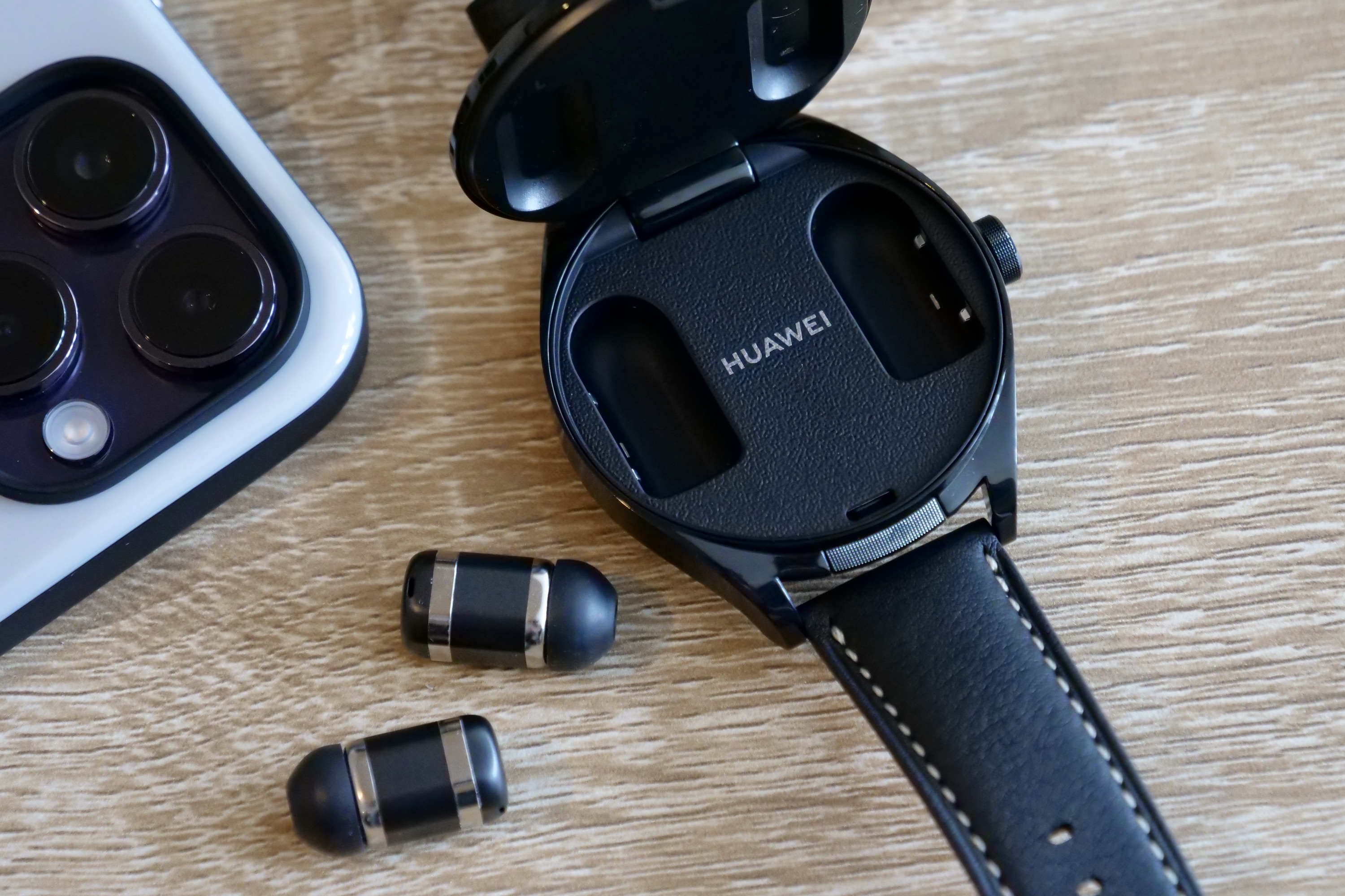 The Huawei Watch Buds's watch open, with earbuds next to it.