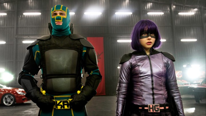 Two masked superheroes stand next to each other in Kick-Ass 2.