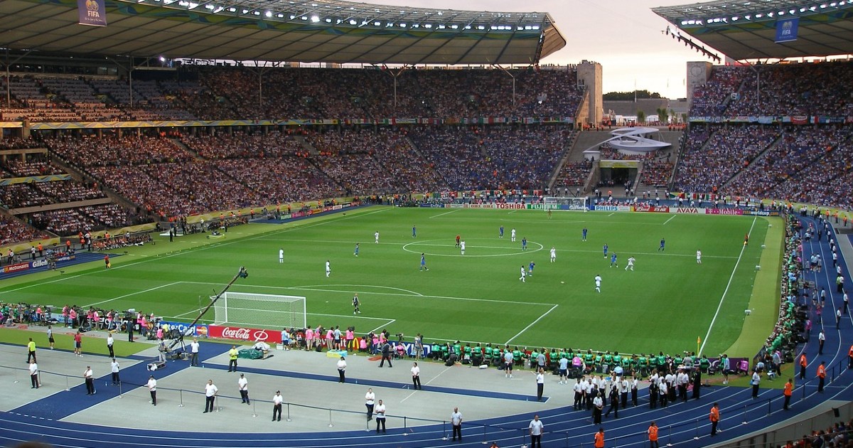 Massive open air soccer stadium with a game in play