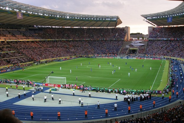 tech news Massive open air soccer stadium with a game in play.