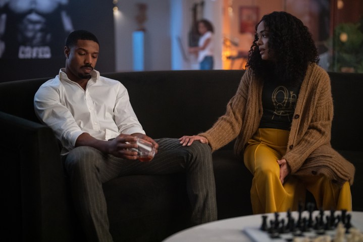 Michael B. Jordan sits on a couch with Tessa Thompson in Creed 3.