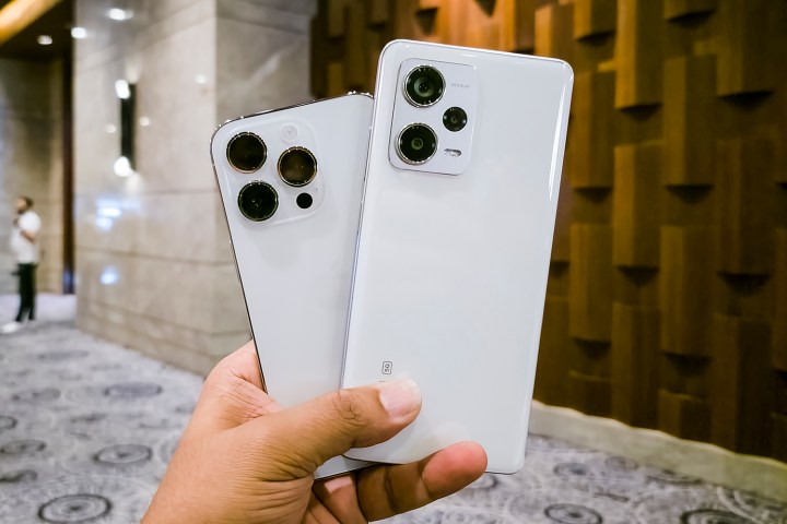 White Xiaomi Redmi Note 12 Pro Plus versus white iPhone 14 Pro in camera face-off.