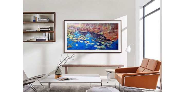 The Samsung 65-inch The Frame QLED TV placed on a wall in an attractive living room.