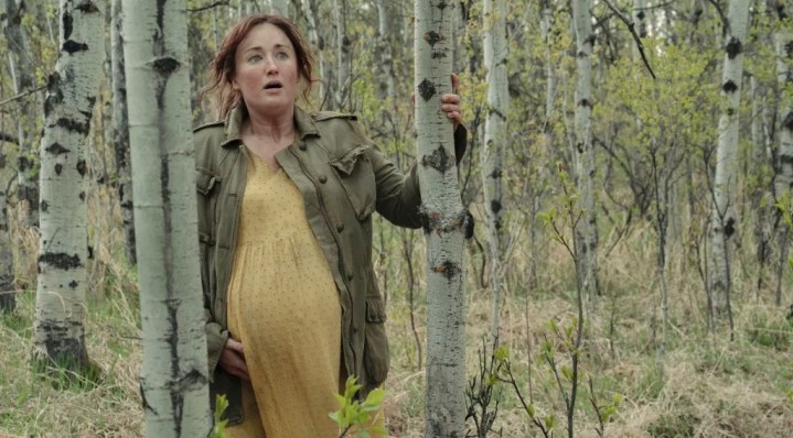 Ashley Johnson walks in a forest in The Last of Us.