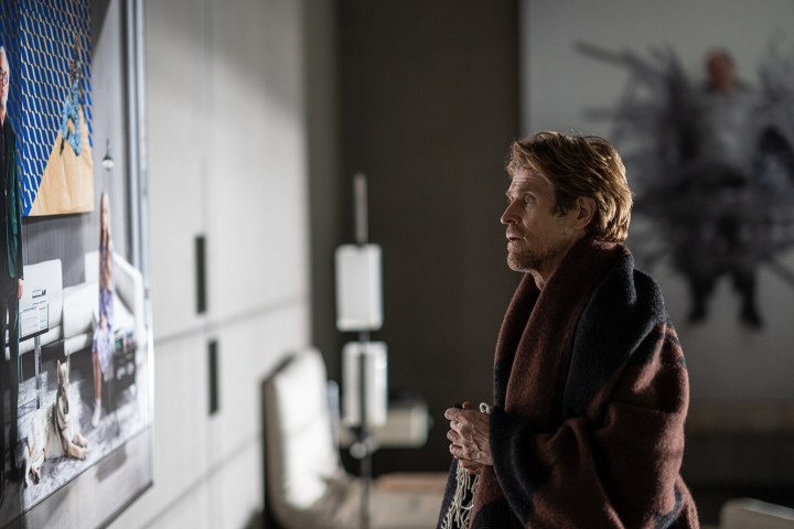 Willem Dafoe looks at a photograph in Inside.
