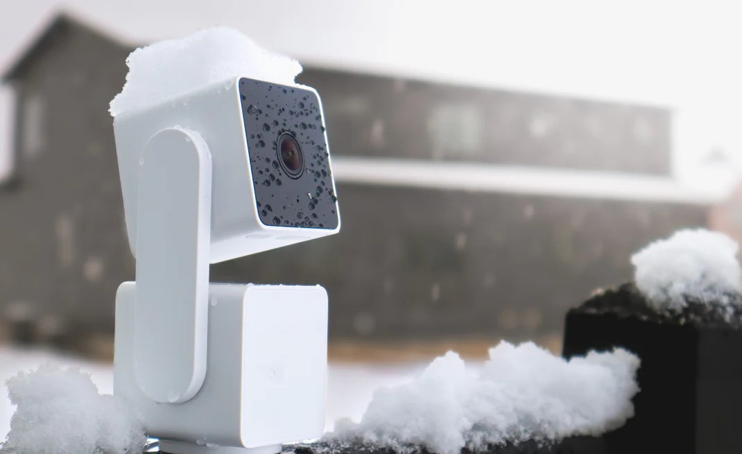 A Wyze camera placed outside in the snow.