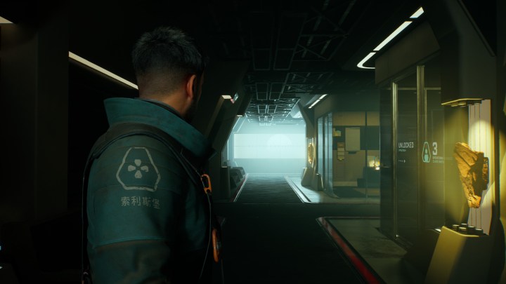 A character stands in a hallway in Fort Solis.