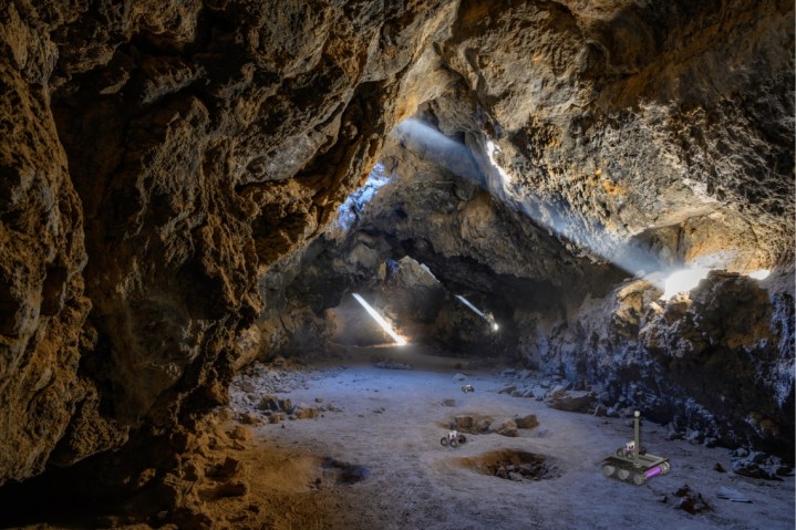 In this artist's impression of the breadcrumb scenario, autonomous rovers can be seen exploring a lava tube after being deployed by a mother rover that remains at the entrance to maintain contact with an orbiter or a blimp. 