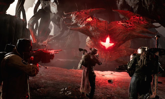Three characters shoot at a boss in Remnant 2.
