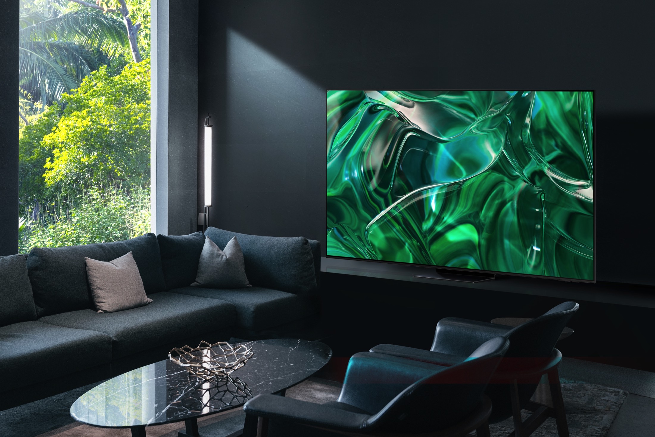 Samsung 2023 S95C QD-OLED TV seen in a brightly-lit room near windows.