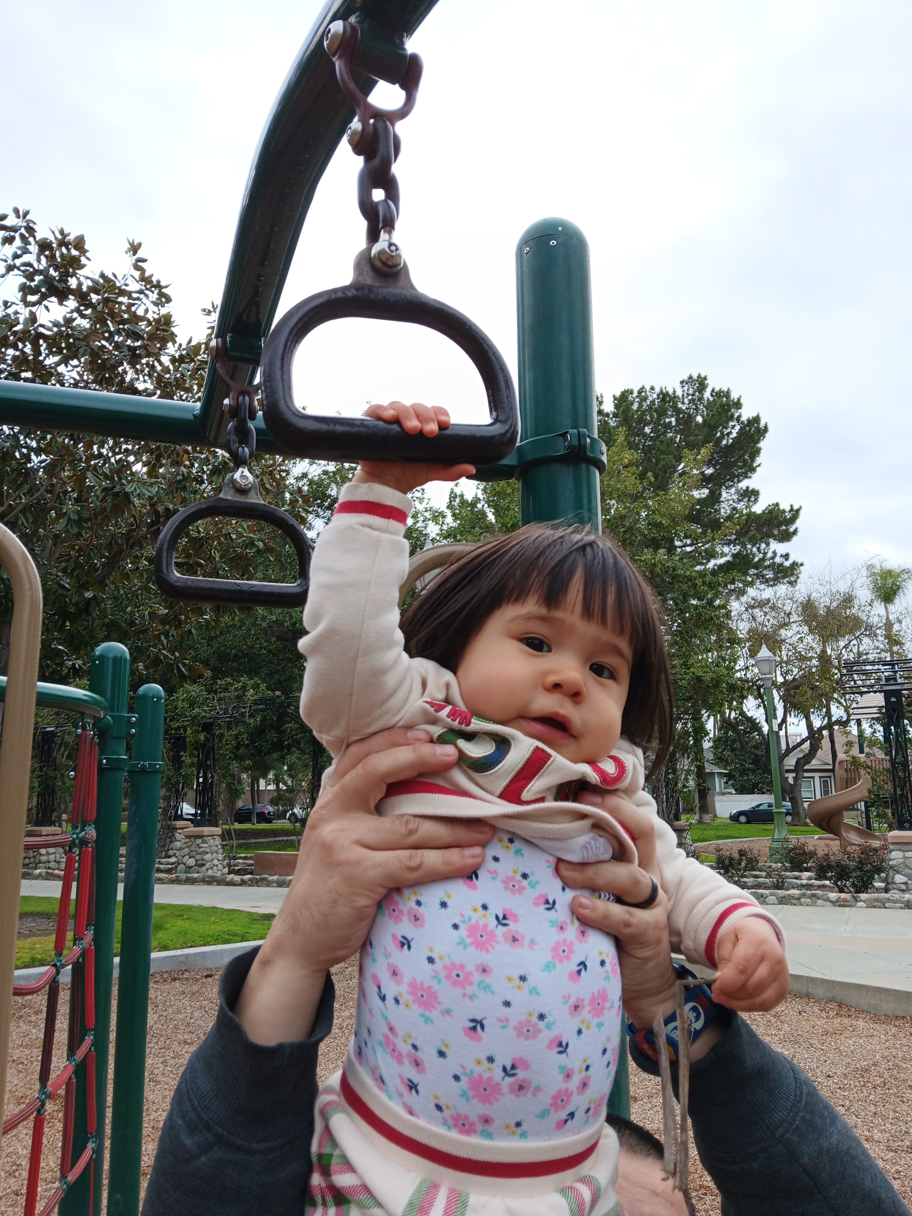 Toddler being carried by dad across monkey bars taken with Samsung Galaxy A14 5G
