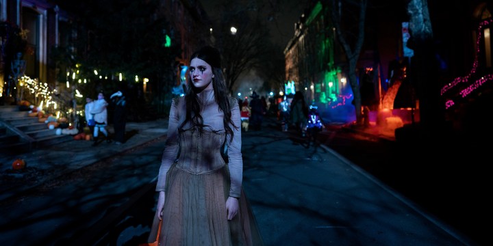 Leanne dressed up for Halloween walking outside in a scene from Servant.