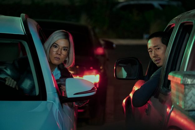 Ali Wong and Steven Yeun lean out of their car windows in Beef.