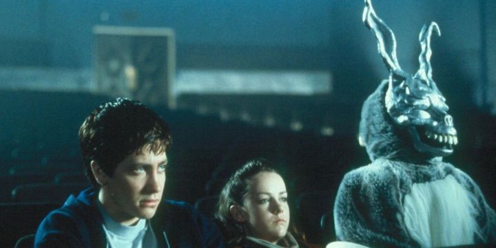 Donnie Darko sits in a movie theater with a demented bunny named Frank