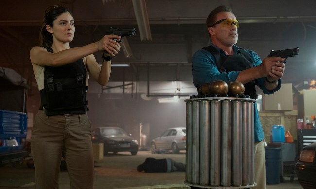 A woman and a man points their guns in a scene from FUBAR.