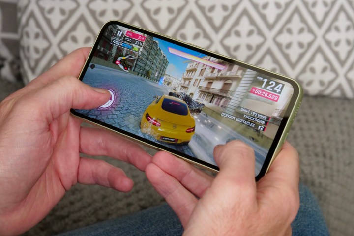 A person playing Asphalt 9: Legends on the Samsung Galaxy A54.