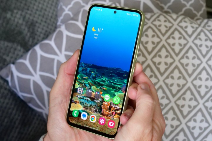 A person holding the Samsung Galaxy A54, showing the screen.
