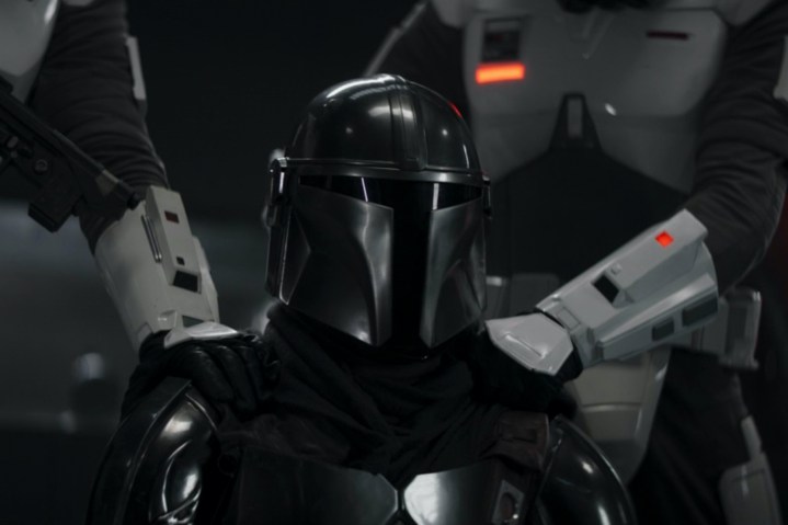 Imperial troopers hold down Din Djarin in The Mandalorian season 3 episode 7.