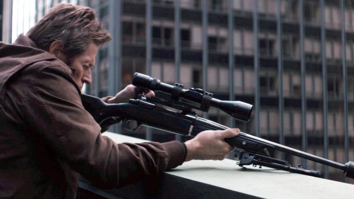 Marcus (Willem Dafoe) aiming a sniper rifle in John Wick