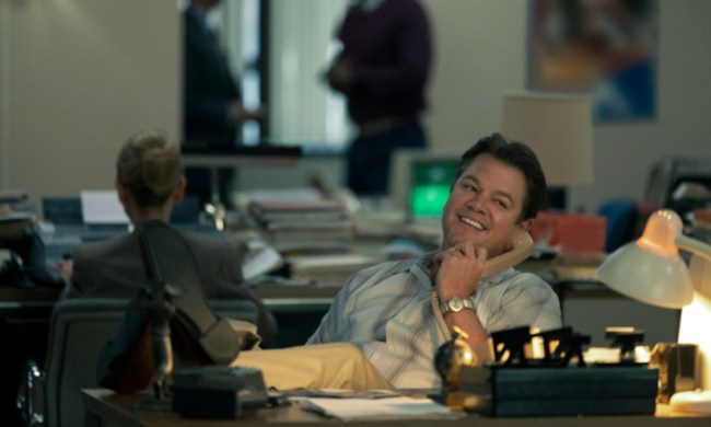 Matt Damon sits at his desk on the in Air.