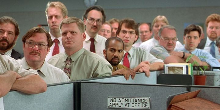 Office employees stand in a meeting in office Space