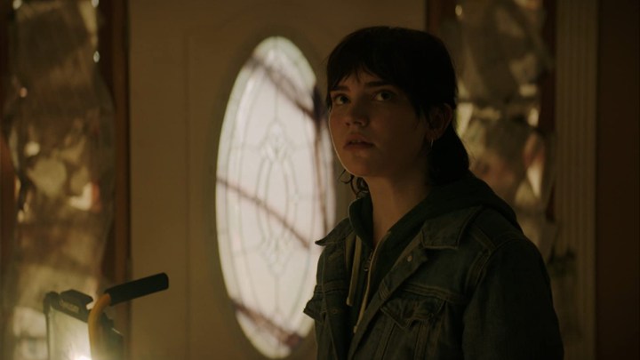 A girl stands outside a door in The Boogeyman.
