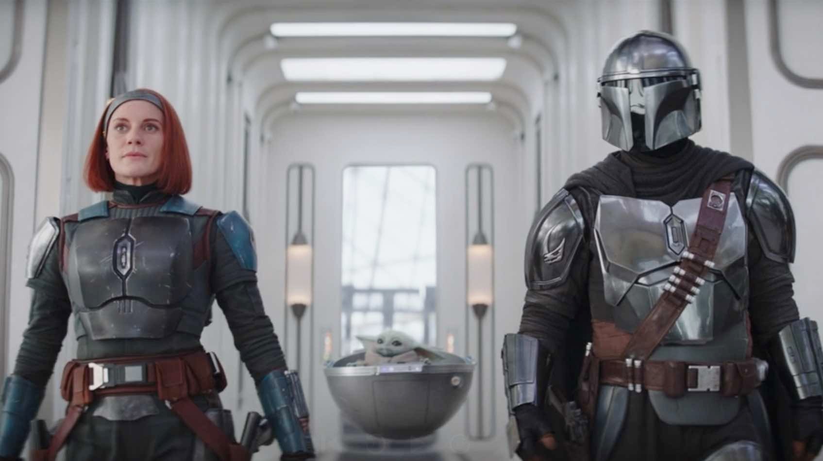 Bo-Katan, Grogu, and Din walk down the hallway in The Mandalorian.