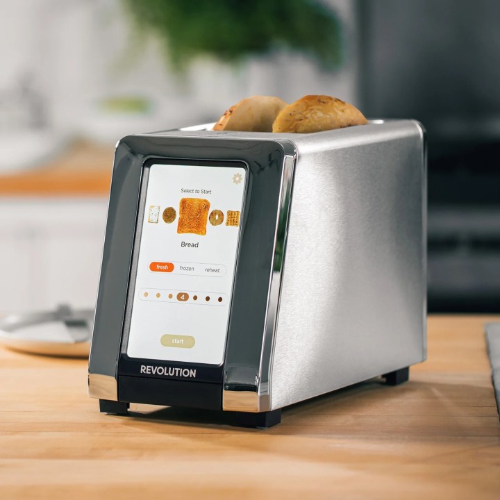 The InstaGlo Toaster on a wooden countertop.