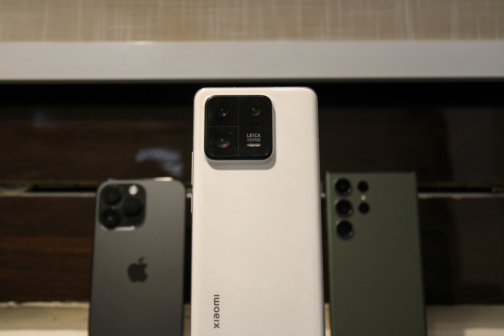 Xiaomi 13 Pro with iPhone 14 Pro Max and Galaxy S23 Ultra in the background.