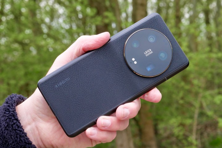 The Xiaomi 13 Ultra held in a man's hand.