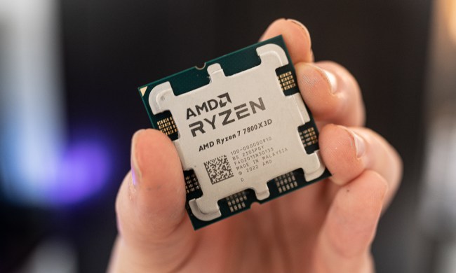 AMD Ryzen 7 7800X3D held between fingertips.