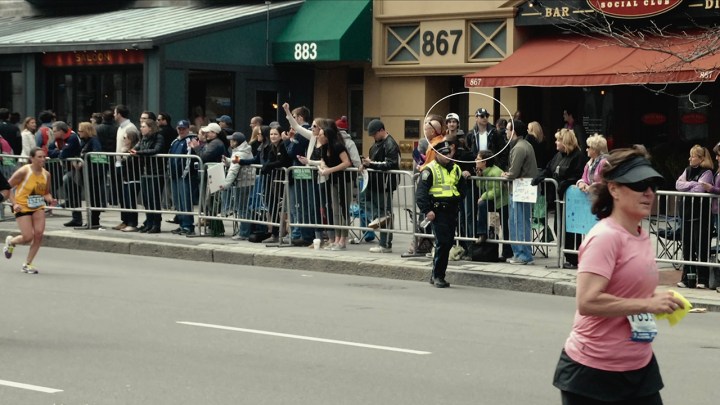 A crowd watching the Boston Marathon in 2013, the two bombers circled in a photo within the crowd.