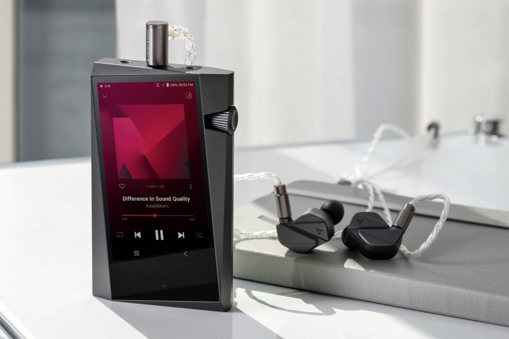Astell&Kern SR35 digital audio player with earbuds.
