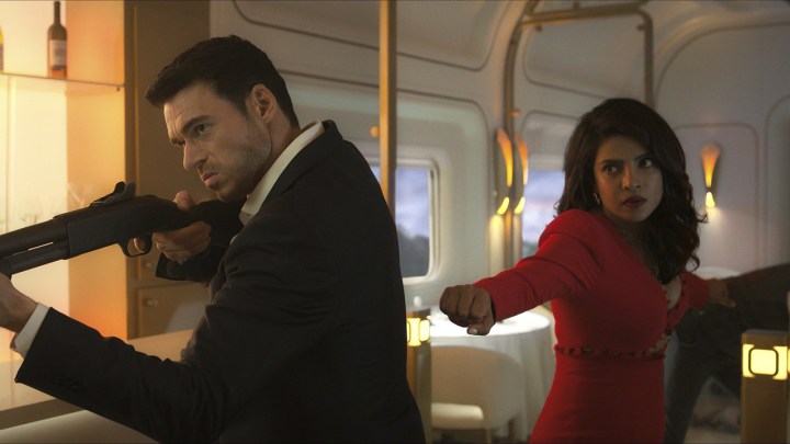理查德·麦登 (Richard Madden) 在地铁上挥舞着步枪，朴雅卡·乔普拉·乔纳斯 (Priyanka Chopra Jonas) 站在他身后，挥舞着拳头，这是 Amazon Prime Freevee 上《Citadel》中的场景。