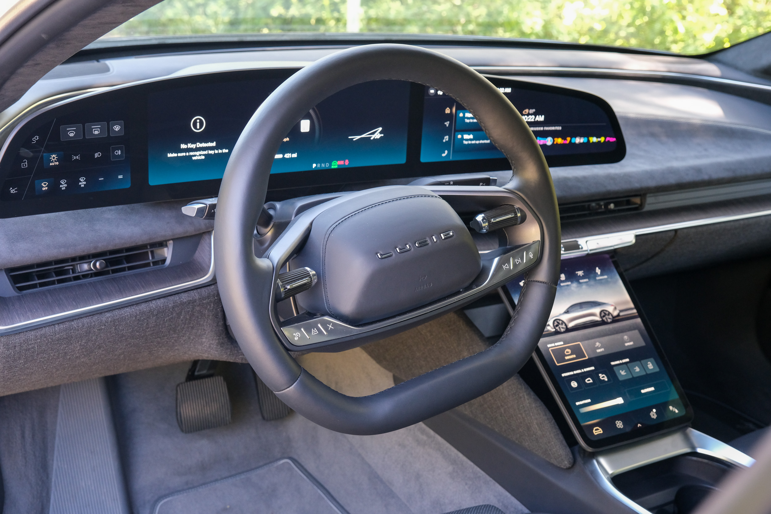 Interior view of the dash and steering wheel in a Lucid Air. 