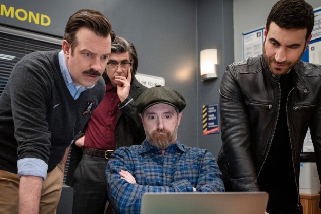 Four men look at a computer in Ted Lasso season 3.