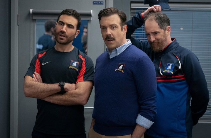 Ted and 2 men look surprised in Ted Lasso season 3.