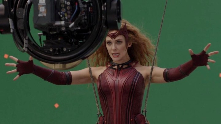 A woman raises her hands in Marvel Studios: Assembled.