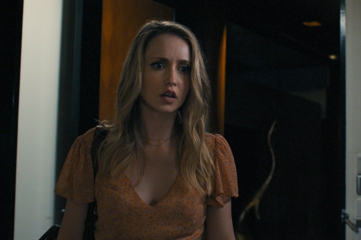 Emily Tennant stands in a doorway in Influencer.