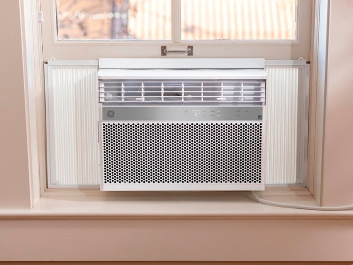 The GE 14,000 BTU smart window air conditioner mounted in a window.