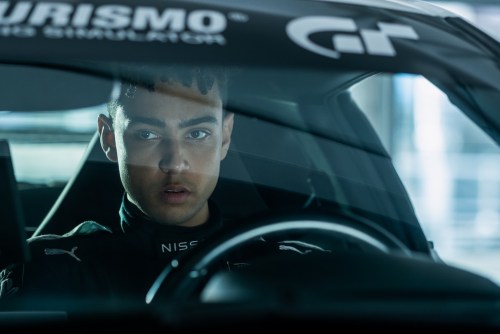 A man sits behind the steering wheel in Gran Turismo.