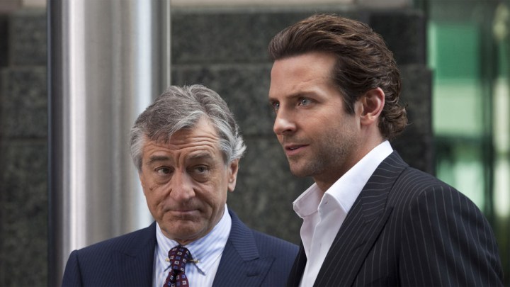 Robert De Niro and Bradley Cooper stand next to each other and stare in Limitless.