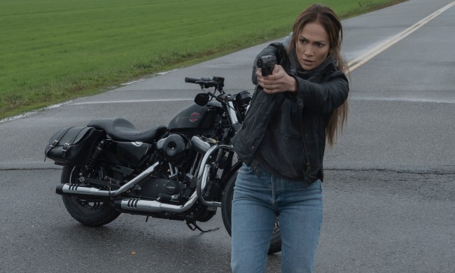 Jennifer Lopez points a gun while in front of her motorcycle in The Mother.