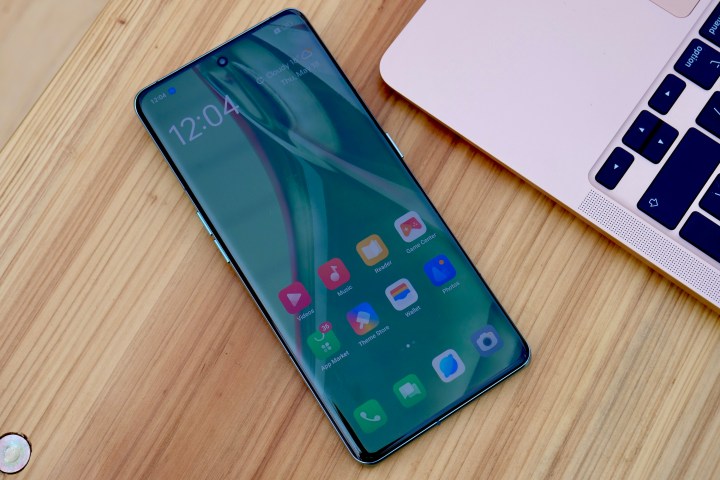 The Oppo Find X6 Pro face up on a table, showing the screen.