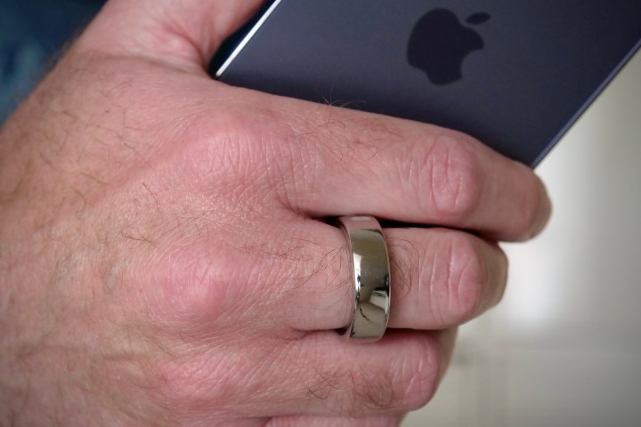 The Oura Ring on a person's finger.
