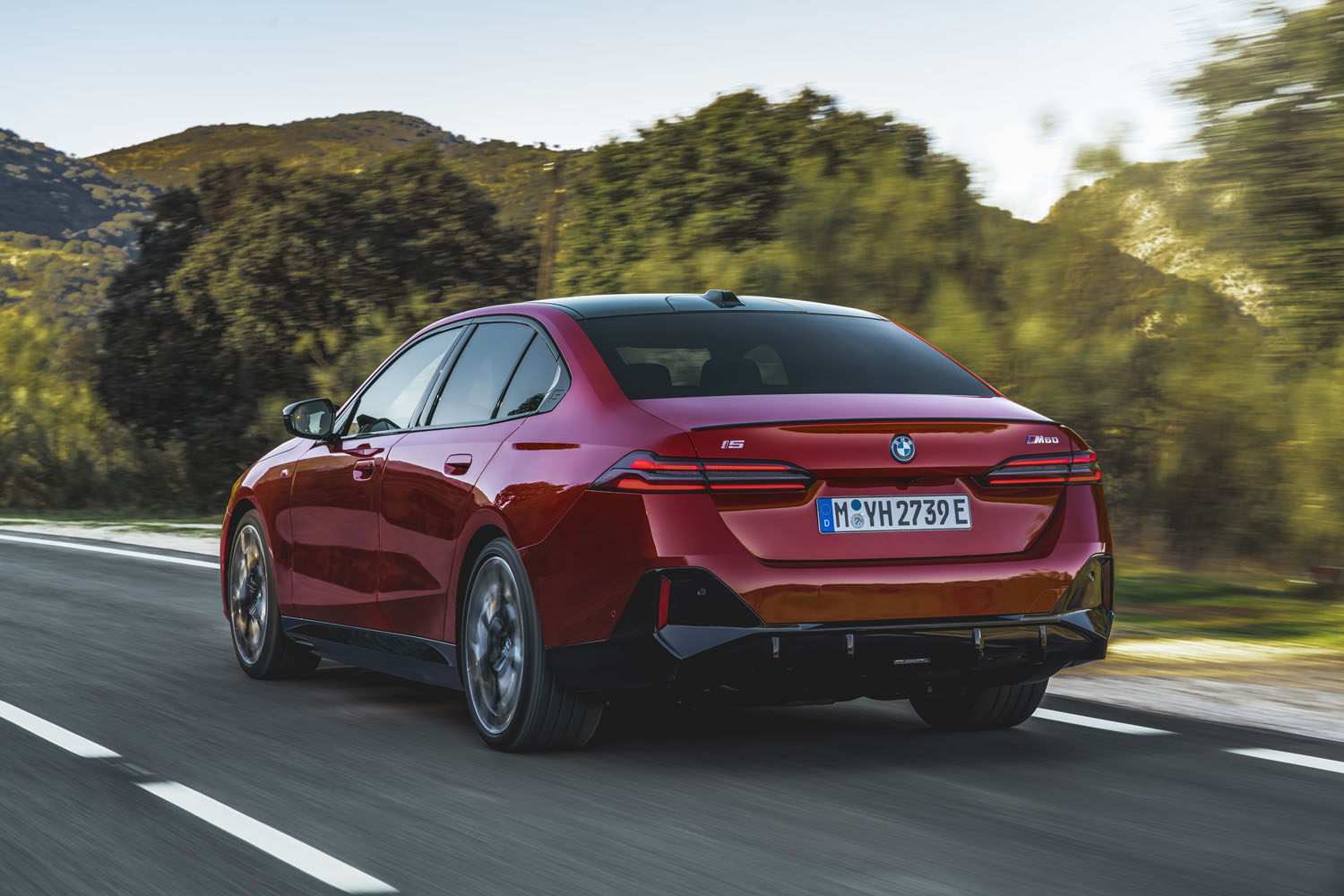 A view of the rear of a red 2024 BMW i5.