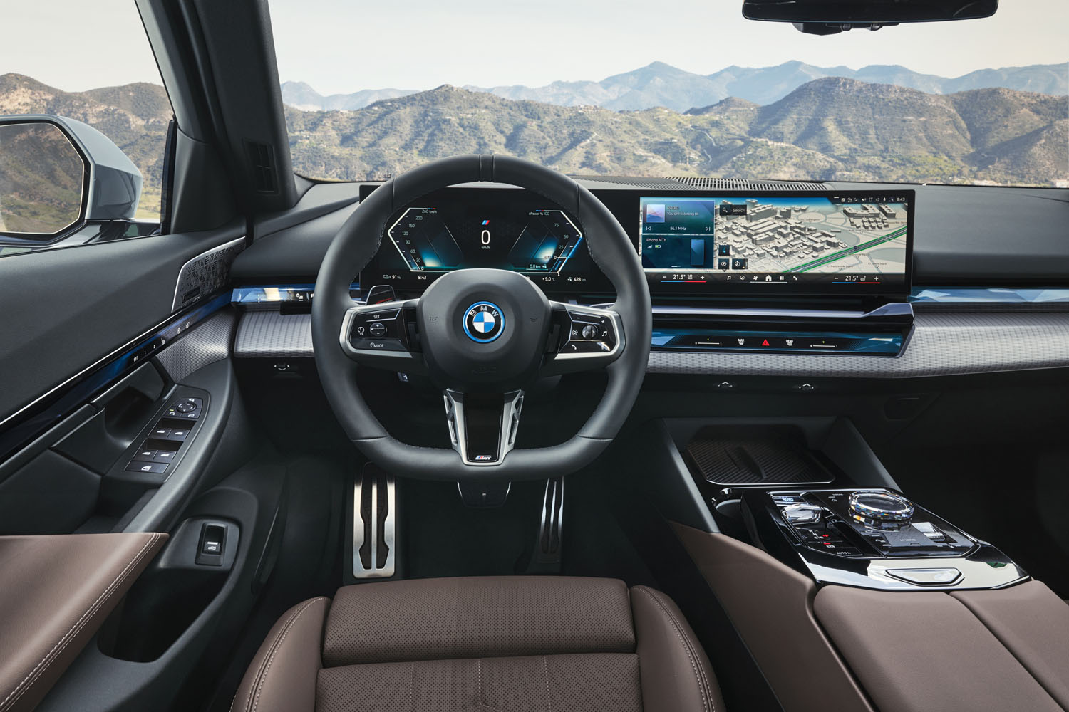 The steering wheel and dash of a 2024 BMW i5.