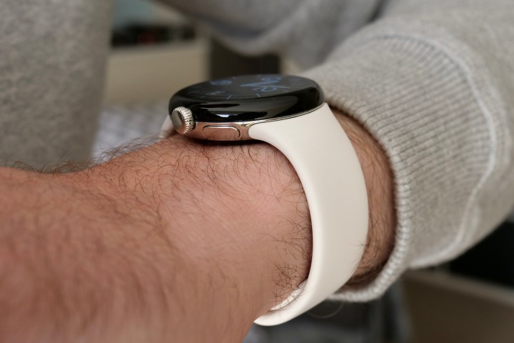The Pixel Watch on a person's wrist, seen from the side.